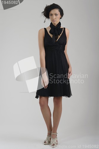 Image of elegant woman in fashionable dress posing in the studio
