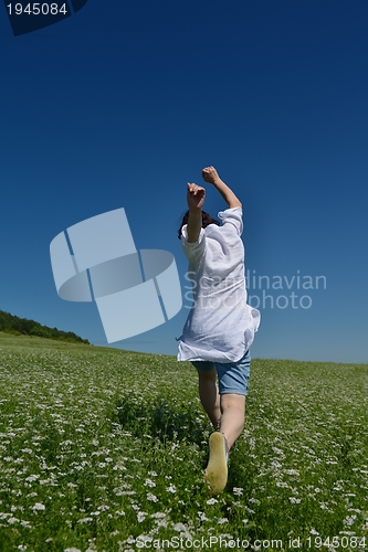 Image of Young happy woman in green field