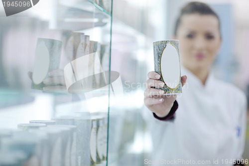 Image of pharmacist chemist woman standing in pharmacy drugstore