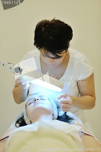 Image of woman with facial mask in cosmetic studio