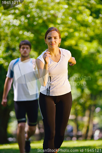 Image of Young couple jogging