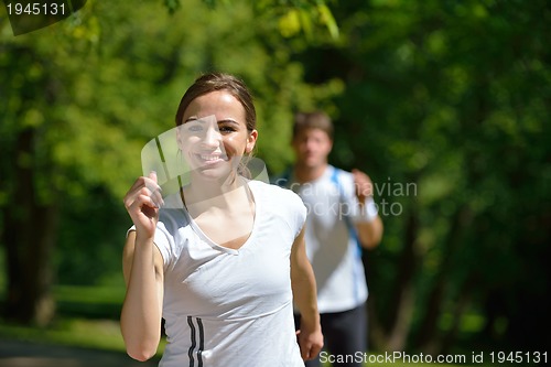 Image of Young couple jogging at morning