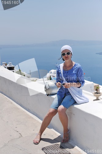 Image of Greek woman on the streets of Oia, Santorini, Greece