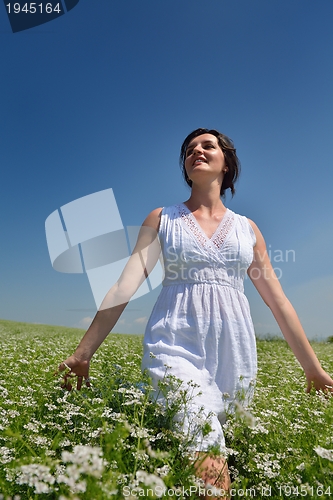 Image of Young happy woman in green field