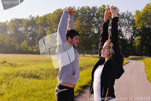 Image of Couple doing stretching exercise  after jogging