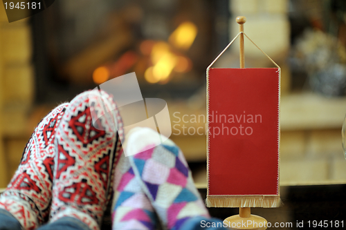 Image of Young romantic couple relax on sofa in front of fireplace at hom