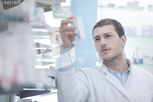 Image of pharmacist chemist man in pharmacy drugstore