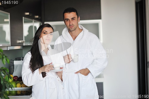 Image of Young love couple taking fresh morning cup of coffee