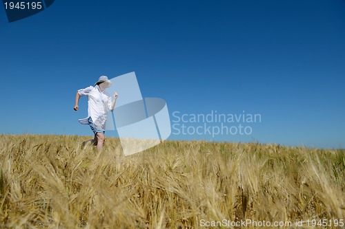 Image of young woman in wheat field at summer