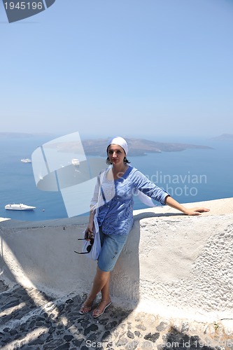 Image of Greek woman on the streets of Oia, Santorini, Greece