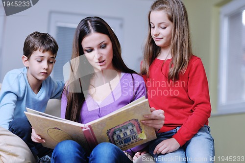 Image of young mom play with their kids at home and reading book