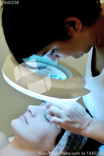 Image of woman with facial mask in cosmetic studio