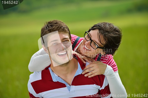 Image of Portrait of romantic young couple smiling together outdoor