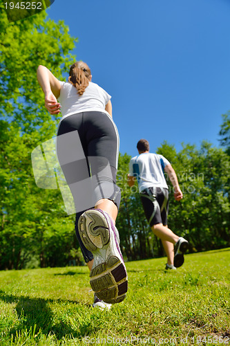 Image of Young couple jogging