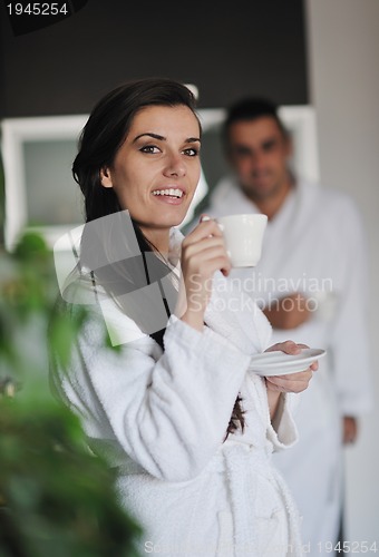 Image of Young love couple taking fresh morning cup of coffee