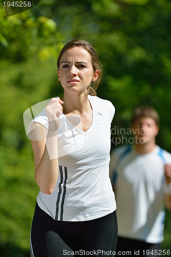 Image of Young couple jogging at morning