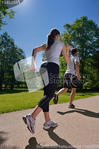 Image of Young couple jogging at morning