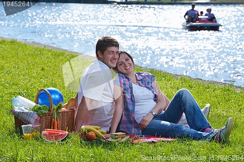 Image of happy young couple having a picnic outdoor