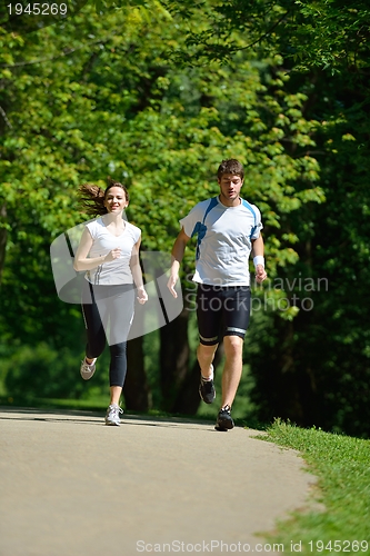 Image of Young couple jogging at morning