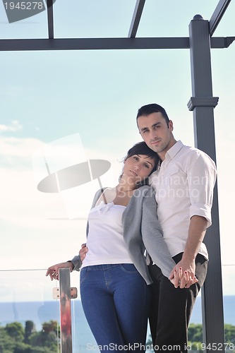 Image of couple relaxing on balcony