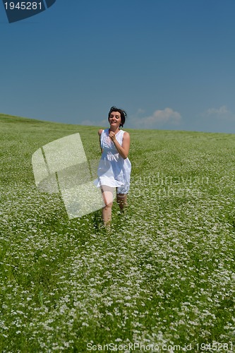 Image of Young happy woman in green field