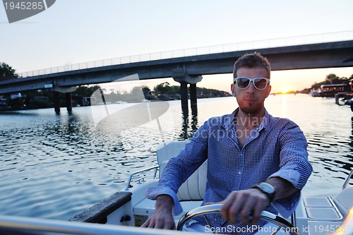 Image of portrait of happy young man on boat