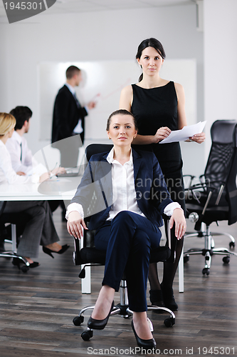 Image of business woman with her staff in background