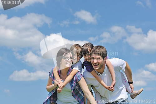 Image of happy young family have fun outdoors