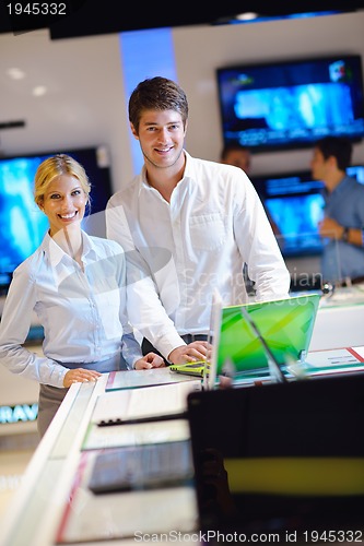 Image of Young couple in consumer electronics store