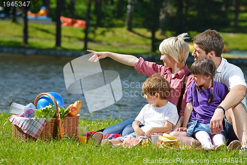 Image of Happy family playing together in a picnic outdoors