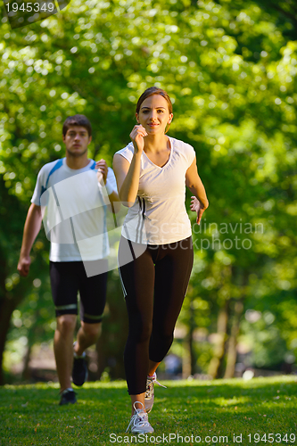 Image of Young couple jogging