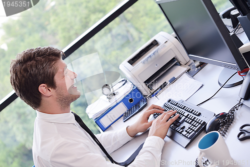 Image of happy young business man at office