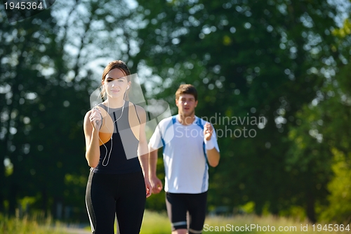 Image of Young couple jogging