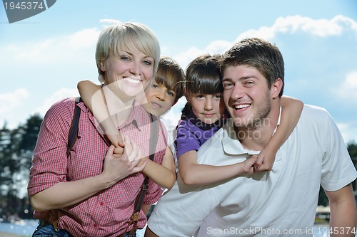 Image of happy young family have fun outdoors