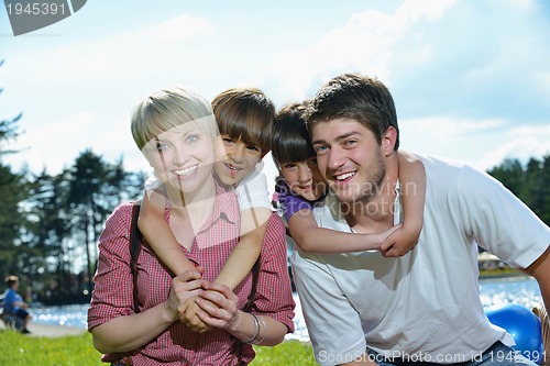 Image of happy young family have fun outdoors