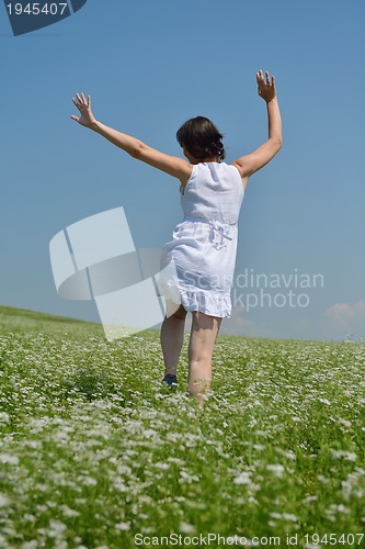 Image of Young happy woman in green field