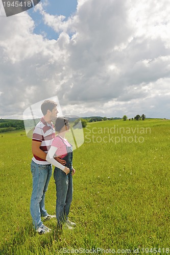 Image of Portrait of romantic young couple smiling together outdoor