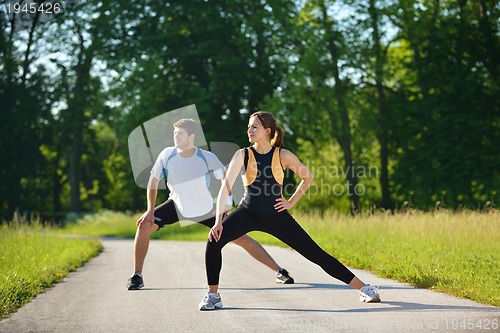 Image of Couple doing stretching exercise  after jogging