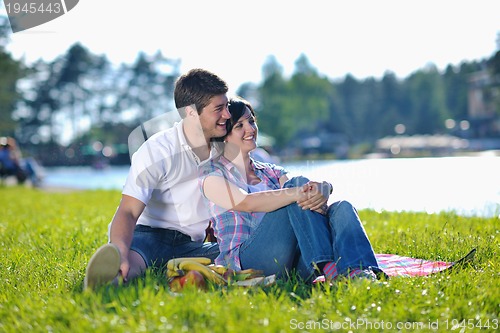 Image of happy young couple having a picnic outdoor