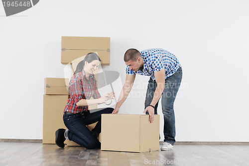 Image of Young couple moving in new house