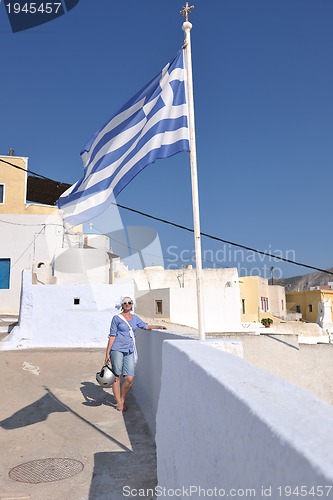 Image of Greek woman on the streets of Oia, Santorini, Greece