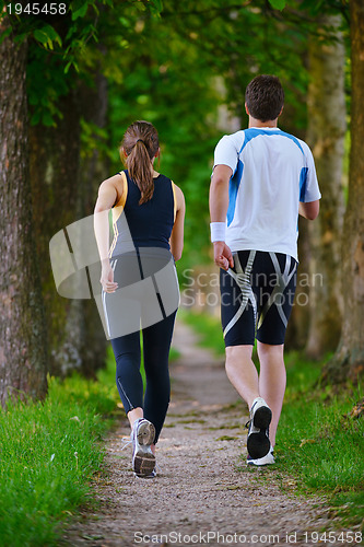 Image of Young couple jogging