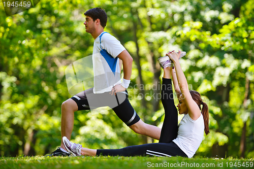 Image of Couple doing stretching exercise  after jogging
