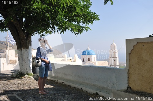 Image of Greek woman on the streets of Oia, Santorini, Greece