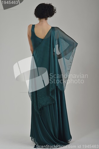 Image of elegant woman in fashionable dress posing in the studio