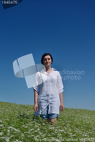 Image of Young happy woman in green field