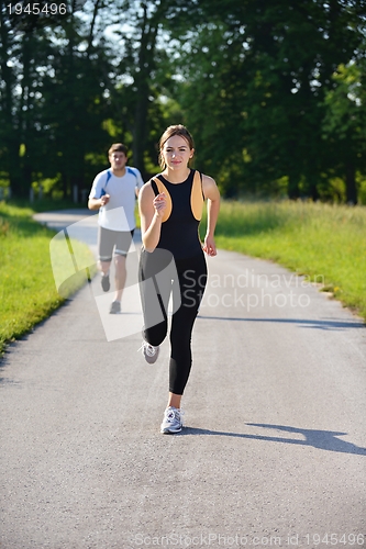 Image of Young couple jogging