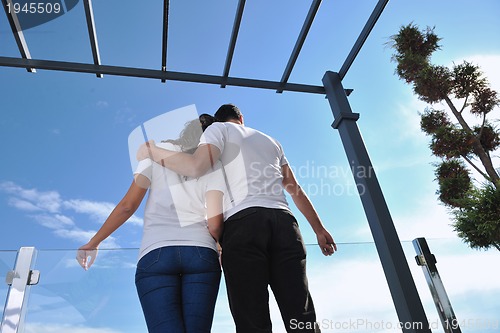 Image of couple relaxing on balcony