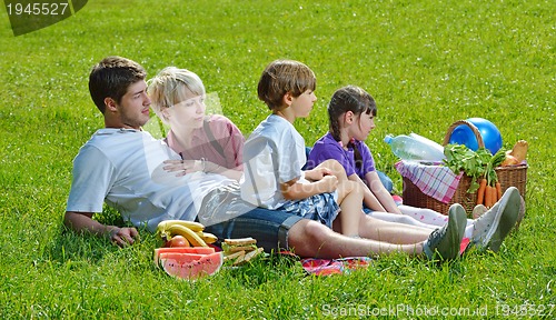 Image of Happy family playing together in a picnic outdoors