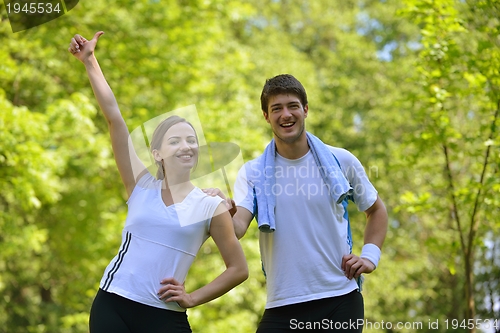 Image of Couple doing stretching exercise  after jogging